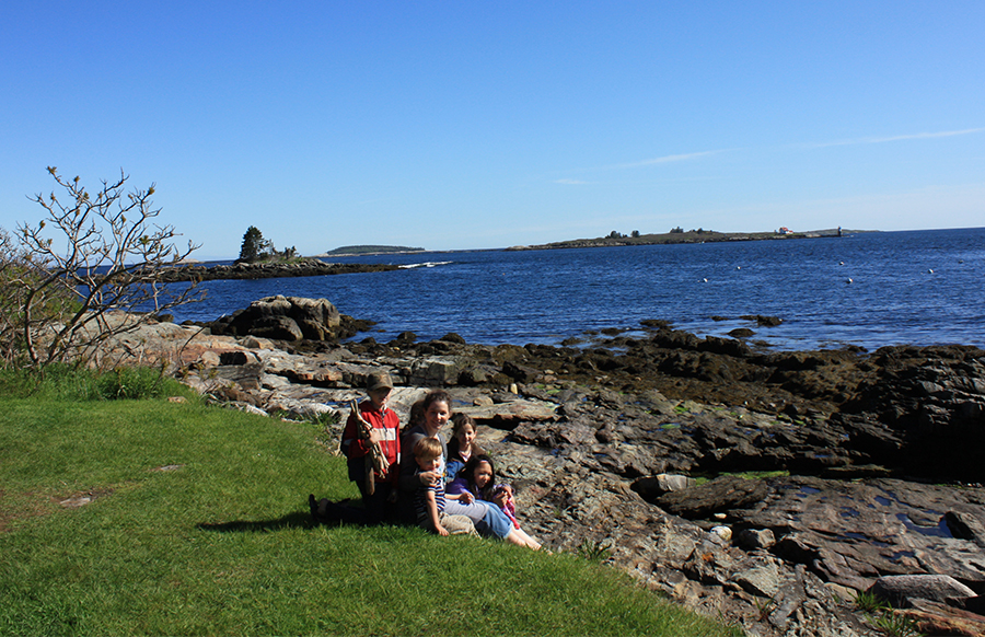 family on rocks near ocean